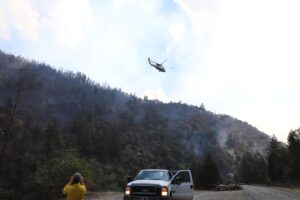 Helicopter flying over smoky areas on Rum Creek Fire.